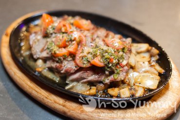 Sizzling Cedar River Ribeye at Trade Winds Tavern gastropub in Convoy Sizzling Cedar River Ribeye at Trade Winds Tavern gastropub in Convoy