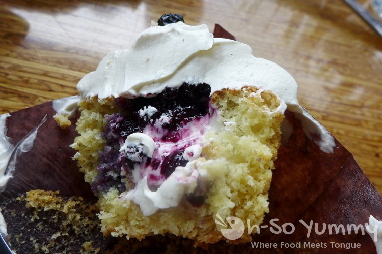 Eclipse Chocolates - Blueberry Cheesecake Cupcake cut open Eclipse Chocolates - Blueberry Cheesecake Cupcake cut open