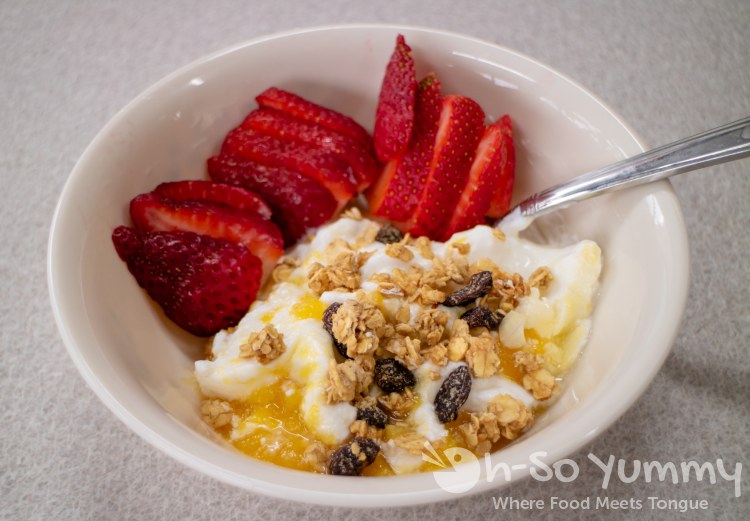 Yoplait mango french yogurt with strawberries and granola Yoplait mango french yogurt with strawberries and granola