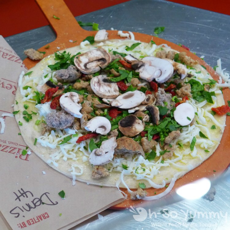 customized pizza ready to bake at PizzaRev customized pizza ready to bake at PizzaRev