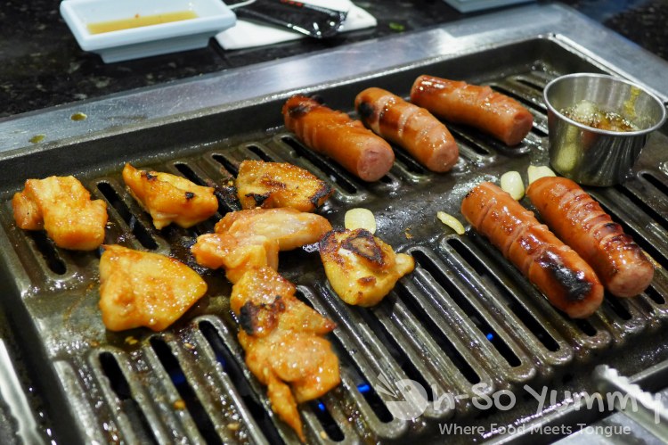 Tsuruhashi Japanese BBQ - grilling chicken and sausages Tsuruhashi Japanese BBQ - grilling chicken and sausages